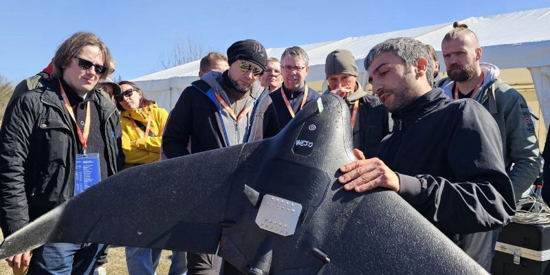 Man showcasing drone to crowd