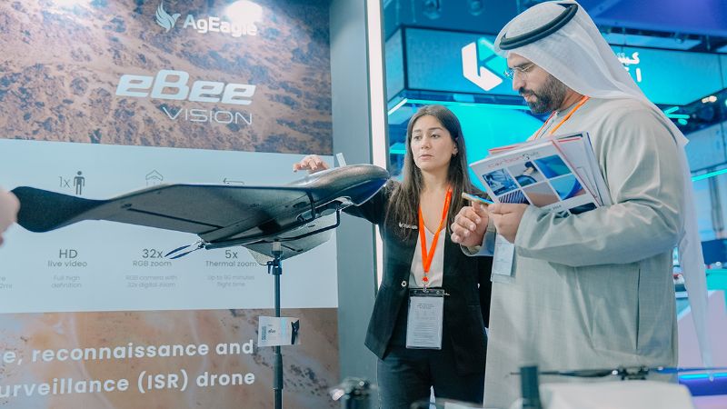 woman showing ebee visioin exhibit to man